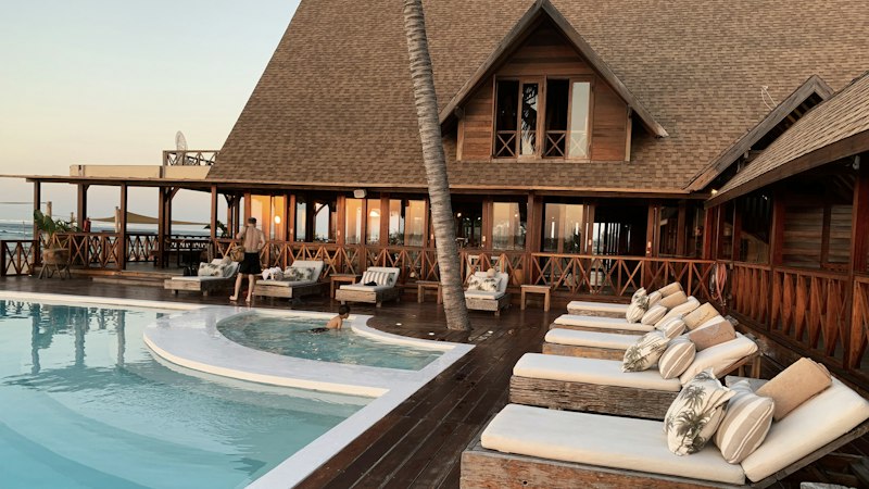 Luxury tropical resort infinity pool representing premium upscale travel packages