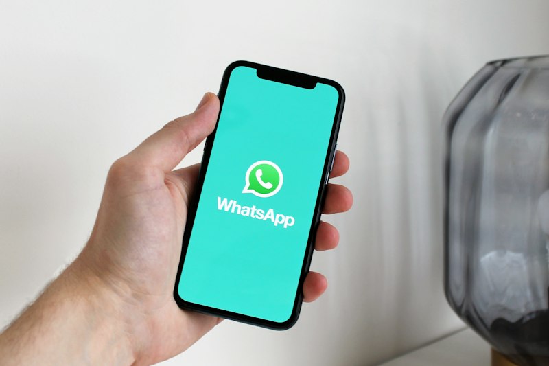 Smartphone with WhatsApp messaging application for travel agency client communications